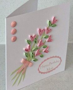 a birthday card with pink flowers and green leaves