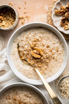 oatmeal with walnuts in a bowl and two bowls on the side