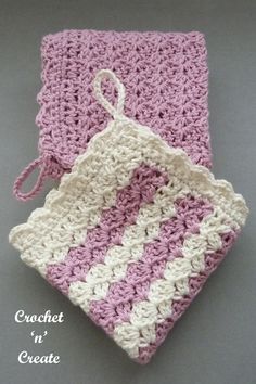 two crocheted dishcloths sitting next to each other on a gray surface