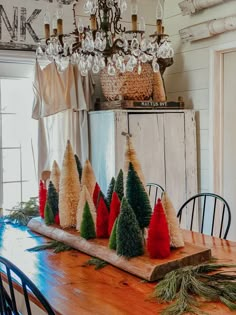 a wooden table topped with christmas trees on top of it