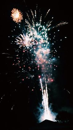 fireworks are lit up in the night sky