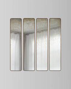 four rectangular mirrors hanging on the wall