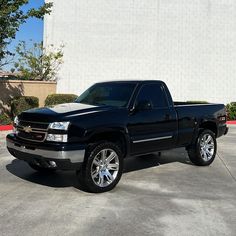 a black truck parked in front of a building