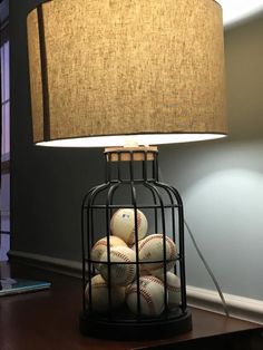 a lamp that is next to a cage with stuffed animals in it on the table