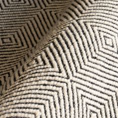 a black and white rug with an interesting pattern on it's surface, close up