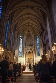 the bride and groom are walking down the aisle at their wedding ceremony in an old cathedral