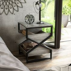 a bed room with a neatly made bed and a table in front of a window