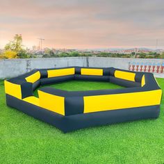 an inflatable couch sitting on top of a lush green field