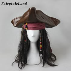 a white mannequin head wearing a pirate hat with long black hair and beads