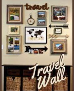 a wall filled with pictures and framed photos next to wicker baskets on top of a wooden table