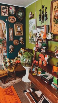 a living room filled with furniture and pictures on the wall