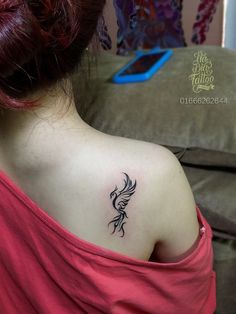 a woman with a tattoo on her back shoulder