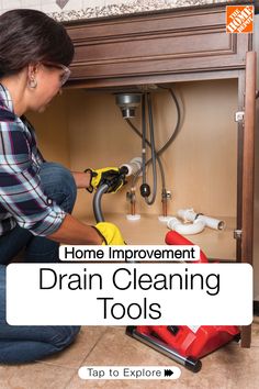 a woman is working under the sink in her kitchen with text overlay that reads home improvement drain cleaning tools