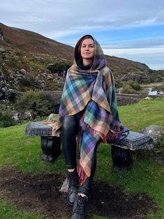 "Hooded Supersoft Lambswool Cape, Ruana, Wrap , Shawl - 100% Pure New Wool - Multicolour  Check - One Size Fits All - HANDMADE IN IRELAND LAST PIECES LEFT, WON`T BE RESTOCKED UNTIL FEBRUARY 2023 Our luxury capes are elegantly stylish and wrap you in warmth. They can be worn in all seasons and can cover a multitude of sins! They are both practical and hard wearing and their versatility means they look fantastic in the town or country and work for both special occasions or for everyday wear. - Extremely versatile wrap, - Can be worn so many ways - Can be worn 4 seasons a year. Perfect for Springtime chills, Summer evening walks, Autumn strolls or Winter Winds - Inspired by the style of the Celts in Ireland. - 100% Wool an natural breathable fiber - Decorative brooch pin included - 2 styles t Ruana Wrap, The Celts, Boho Shawl, Evening Shawls, Blanket Shawl, Killarney, Boho Fringe, February 2023, Wrap Shawl