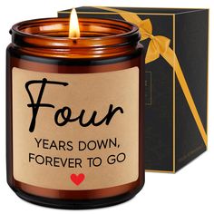 a candle that says four years down, forever to go in front of a box