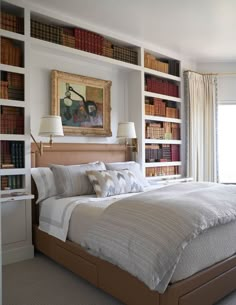 a large bed sitting in front of a book shelf filled with lots of books on top of it