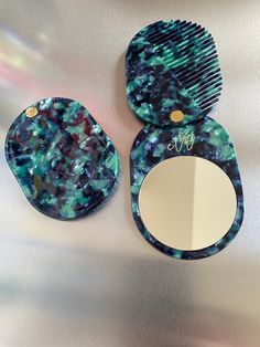 This compact mirror and comb set is the perfect accessory for any woman on the go. Made from acetate and each set is handcrafted, The set includes a folding mirror and a mini slide hair comb, both in unique and vibrant colours. Please note that due to the nature of acetate, the colours may vary slightly from the product pictured. Made from Acetate Glass Mirror Size measurement: Length: 10cm Height: 7cm Weight 52g We offer FREE Royal Mail 48 Hours Tracked for all UK orders. All orders will be dis Folding Mirror, Comb Set, Travel Mirror, Stone Jewellery, Bridemaids Gifts, Etsy Bridesmaid Gifts, Pocket Mirror, Compact Mirror, Green Jade