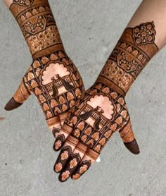 two hands with henna designs on them