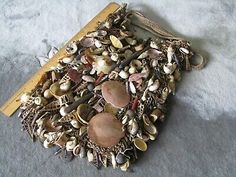 an old wooden board with shells and other things on the bottom, sitting on a carpeted floor