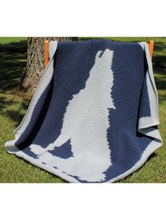 a blue and white crocheted afghan with an image of a dog on it