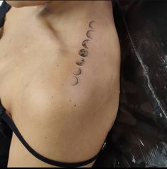 the back of a woman's shoulder with phases on it