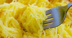 a fork is stuck in some shredded yellow food