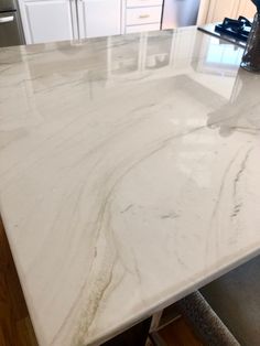 a white marble counter top in a kitchen