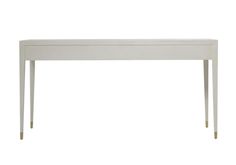 a white table with gold legs and a long drawer on the top, against a white background