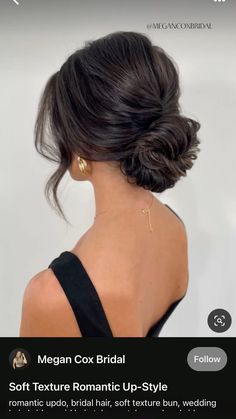 the back of a woman's head with her hair styled into a low bun