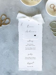 the wedding menu is laid out with scissors and other items