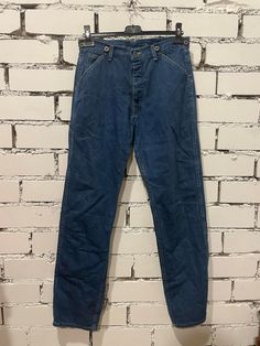 These vintage Lee Boss of the Road 88 jeans from the 60s are a must-have for any denim enthusiast. The classic blue color and regular style make them perfect for any occasion. The denim fabric type ensures durability and comfort, while the size of 32/34 fits most men. The Lee brand has been a trusted name in fashion for years, and these jeans are no exception. The size type is regular, and the inseam and size can be seen in the pictures. These jeans are an excellent addition to any wardrobe and Medium Wash Retro Fitted Jeans, Retro Medium Wash Denim Jeans, Retro Fitted Medium Wash Jeans, Retro Denim Blue Cotton Jeans, Classic Pre-washed Denim Blue Jeans, Vintage Mid-rise Pants For Streetwear, Retro Medium Wash Cotton Jeans, Vintage Denim Blue Streetwear Pants, Retro Dark Wash Denim Pants