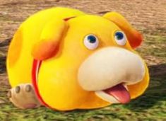 a yellow stuffed animal with big blue eyes and nose is laying on the grass in front of a tree