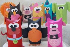 an assortment of colorful paper owls on display