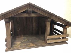 a wooden dog house with two dogs inside