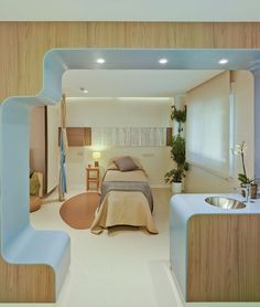 a bed sitting inside of a bedroom next to a sink