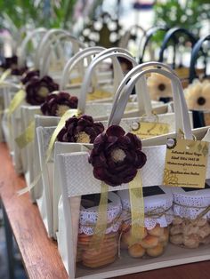 several bags with flowers on them are sitting on a table in front of other items