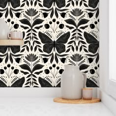 a black and white wallpaper design with flowers on it's back drop in front of a window