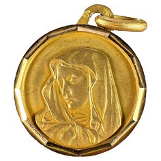 An 18 karat (18K) yellow gold charm pendant designed as a round medal with faceted frame depicting the Virgin Mary. Stamped with the eagle’s head for French manufacture and 18 karat gold, and an unknown maker’s mark. Dimensions: 2 x 1.7 x 0.1 cm (not including jump ring) Weight: 1.51 grams (Chain not included) The Virgin Mary, Maker’s Mark, The Eagle, Gold Medal, Pendant Design, Nails Acrylic, Circle Pendant, Gold Charm, Virgin Mary