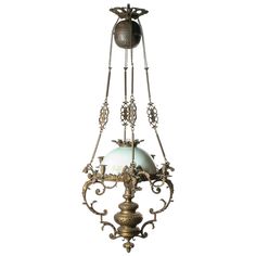 an ornate chandelier with two lights hanging from it's sides and one light on the other side