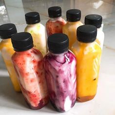 six different types of juice in glass bottles