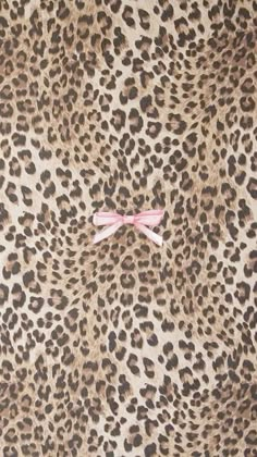 an animal print wall with a pink bow on it