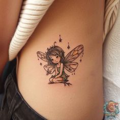 a woman with a tattoo on her stomach has a small fairy tinkerbell sitting on it's belly