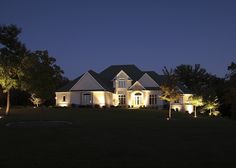 a large house lit up at night in the evening