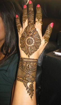 a woman's hand with henna on it