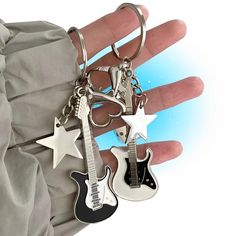 Looking for a unique way to show off your love for guitar and add some personality to your keychain? Look no further than our Shining Stellar Guitar Key Chain! Benifits: Crafted from high-quality materials and designed with intricate detail, this keychain is a mini masterpiece that's sure to grab attention. The star-shaped design adds a touch of whimsy to your keys, while the guitar detail showcases your love for music and all things guitar. With its sturdy construction and durable materials, th Guitar Keys, Whimsical Accessories, Y2k Accessories, Estilo Punk, Style Punk, Guitar Design, Jewelry Making Charms, Vintage Guitars, Pretty Jewellery