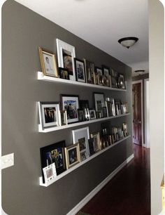 the wall is filled with pictures and frames