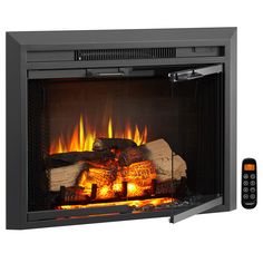 an electric fireplace with fire logs and remotes