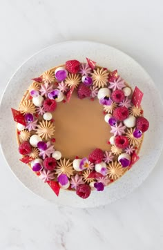 a white plate topped with a cake covered in flowers