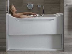 a woman taking a bath in a white sink