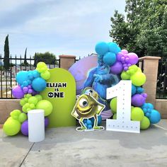 the balloon arch is decorated with monsters and balloons